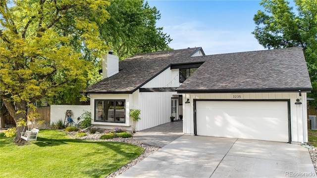 3235 E Easter Pl, Centennial, CO 80122 - modern farmhouse style home with a chimney, a shingled roof, an attached garage, and driveway