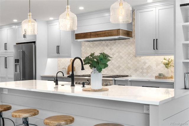 3235 E Easter Pl, Centennial, CO 80122 - kitchen featuring high end fridge, a breakfast bar area, backsplash, hanging light fixtures, and recessed lighting