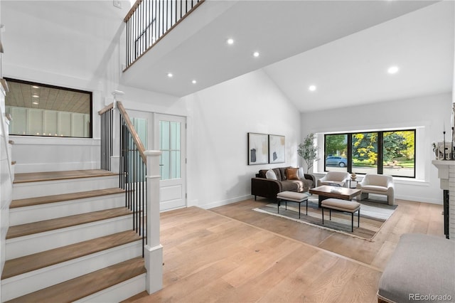 3235 E Easter Pl, Centennial, CO 80122 - living area featuring high vaulted ceiling, stairs, baseboards, light wood finished floors, and recessed lighting
