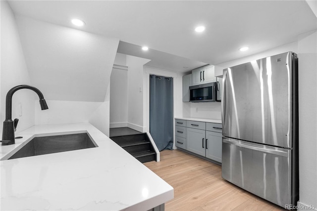 3235 E Easter Pl, Centennial, CO 80122 - kitchen with stainless steel appliances, a sink, light wood-style floors, gray cabinets, and recessed lighting