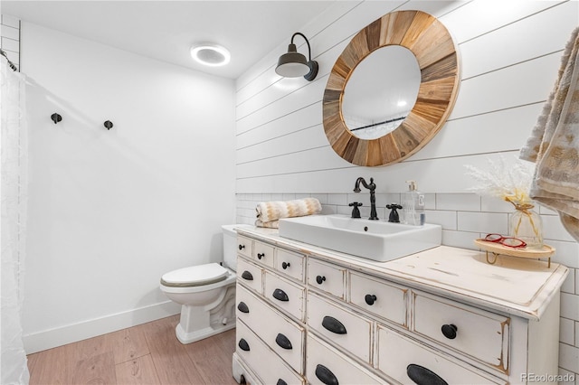 3235 E Easter Pl, Centennial, CO 80122 - bathroom featuring vanity, toilet, wood finished floors, baseboards, and backsplash