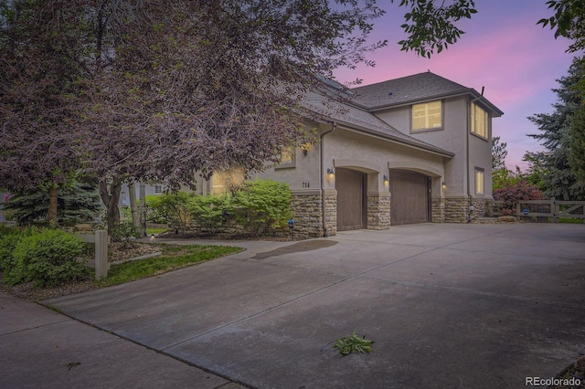 714 Skywalker Pt, Lafayette, CO 80026 - view of front of house featuring stucco siding, concrete driveway, and stone siding
