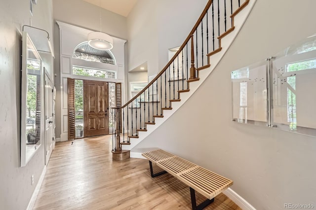 714 Skywalker Pt, Lafayette, CO 80026 - foyer with stairs, wood finished floors, and a towering ceiling