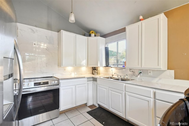 kitchen with white cabinetry, sink, stainless steel appliances, and vaulted ceiling