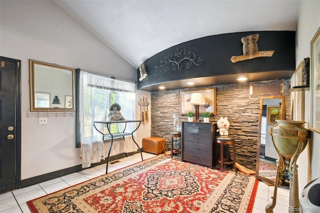 interior space with light tile patterned floors and lofted ceiling