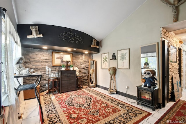 hall with light tile patterned floors and high vaulted ceiling