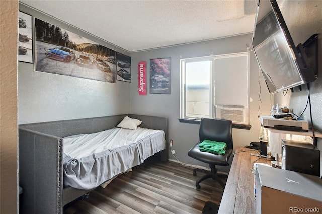 bedroom featuring a textured ceiling, hardwood / wood-style flooring, and cooling unit