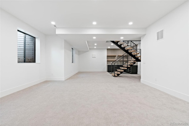 basement featuring light colored carpet