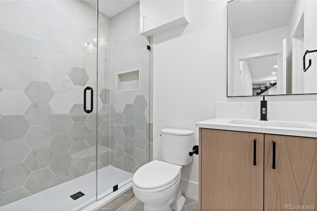 bathroom featuring vanity, toilet, and an enclosed shower