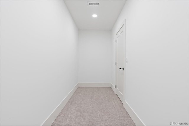 hallway featuring light carpet