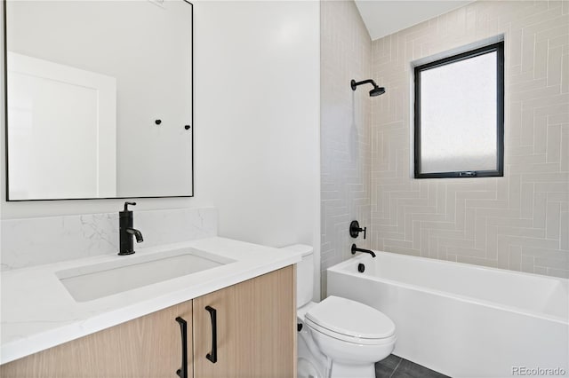 full bathroom with vanity, tiled shower / bath combo, toilet, and tile patterned floors