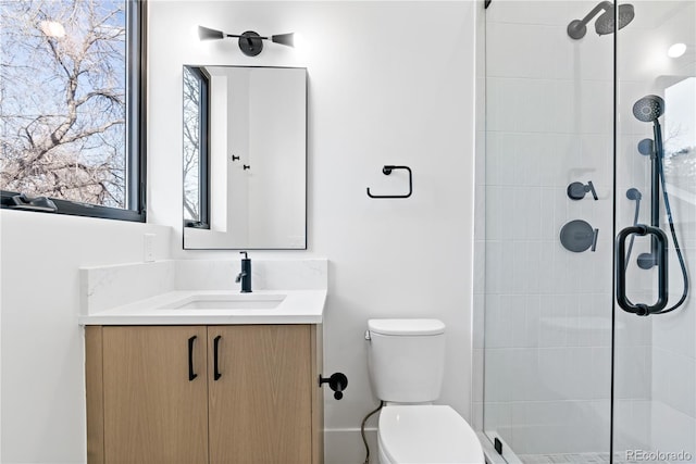 bathroom featuring walk in shower, vanity, and toilet