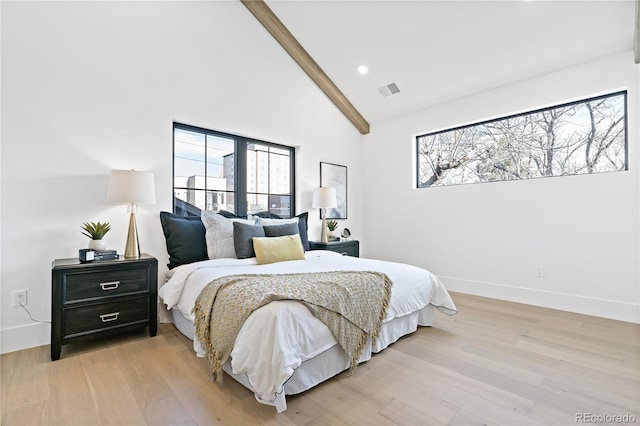 bedroom featuring high vaulted ceiling, light hardwood / wood-style floors, and multiple windows