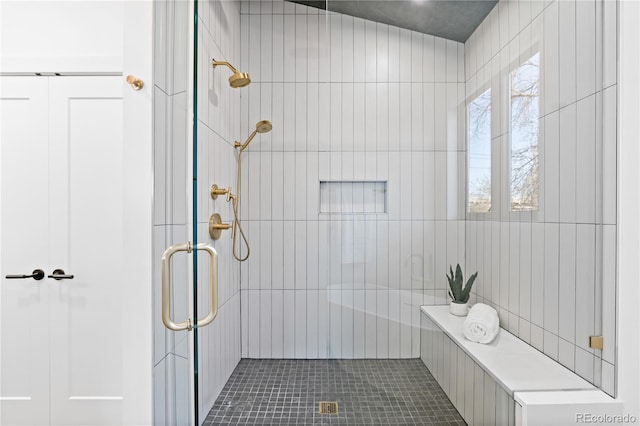 bathroom featuring lofted ceiling, an enclosed shower, and tile patterned floors