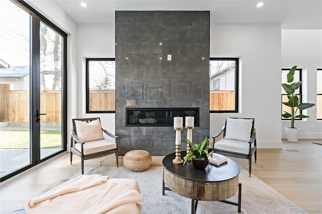 sitting room featuring light hardwood / wood-style flooring and a tile fireplace