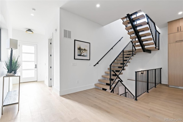 stairs featuring wood-type flooring