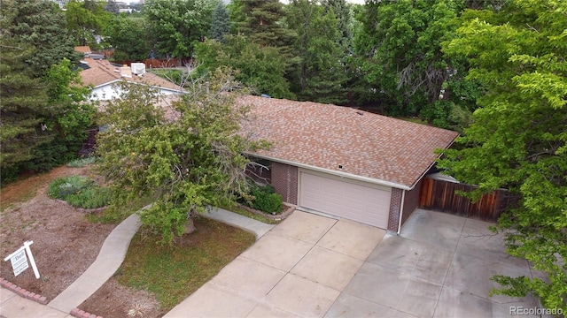 7140 S Uinta St, Centennial, CO 80112 - view of front facade featuring an attached garage, concrete driveway, and brick siding