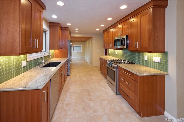 7140 S Uinta St, Centennial, CO 80112 - kitchen with a sink, stainless steel appliances, brown cabinets, light stone counters, and recessed lighting