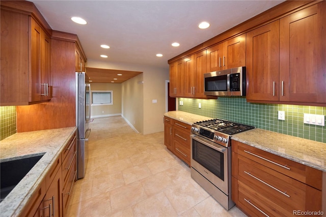 7140 S Uinta St, Centennial, CO 80112 - kitchen with stainless steel appliances, brown cabinets, light stone countertops, and recessed lighting