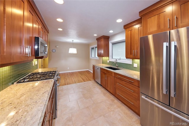 7140 S Uinta St, Centennial, CO 80112 - kitchen with appliances with stainless steel finishes, a sink, baseboards, recessed lighting, and brown cabinetry