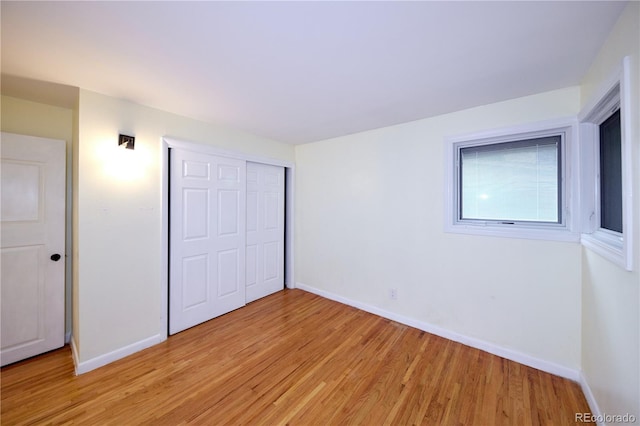 7140 S Uinta St, Centennial, CO 80112 - unfurnished bedroom with light wood-style flooring, a closet, and baseboards