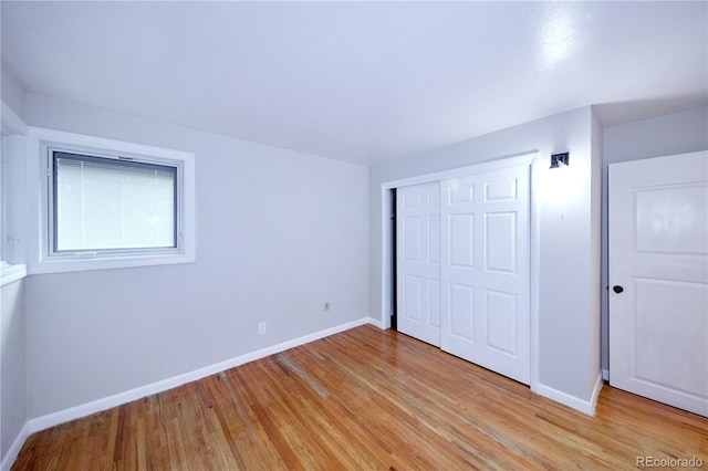 7140 S Uinta St, Centennial, CO 80112 - unfurnished bedroom featuring light wood finished floors, baseboards, and a closet