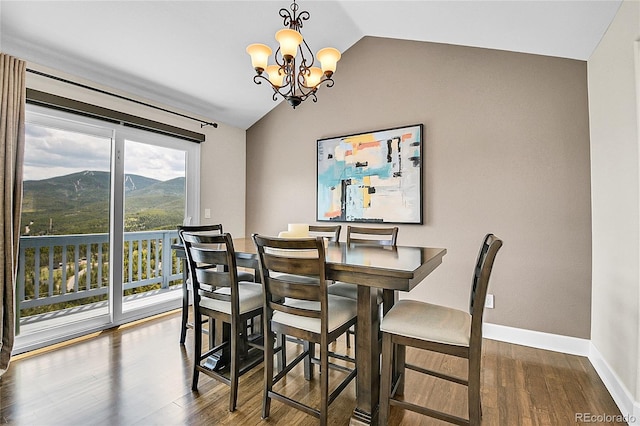 33633 Elk Run, Evergreen, CO 80439 - dining space with lofted ceiling, wood finished floors, a chandelier, baseboards, and a mountain view