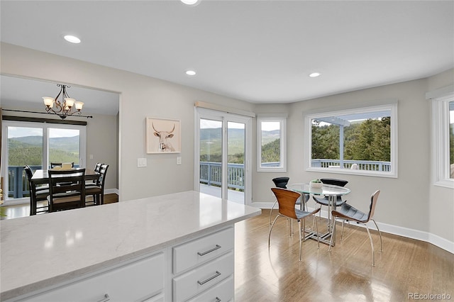 33633 Elk Run, Evergreen, CO 80439 - kitchen featuring white cabinets, a chandelier, light wood finished floors, baseboards, and recessed lighting