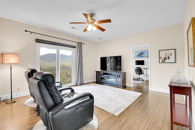 33633 Elk Run, Evergreen, CO 80439 - living area with a ceiling fan, wood finished floors, and baseboards