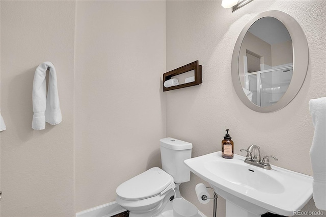 33633 Elk Run, Evergreen, CO 80439 - bathroom with toilet, a sink, and baseboards