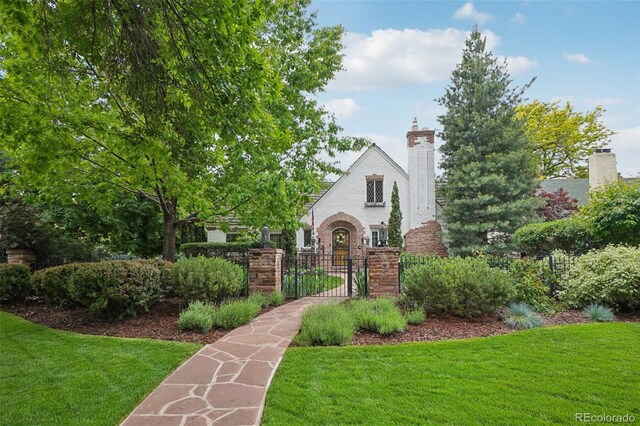 5530 E 6th Avenue Parkway, Denver, CO 80220 - english style home featuring brick siding and a chimney