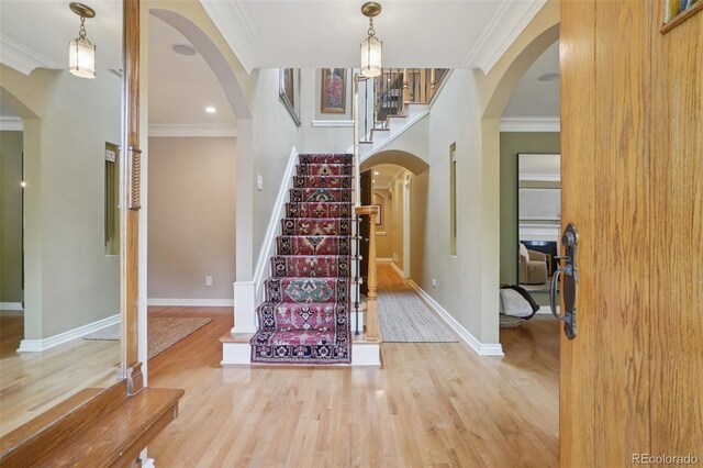 5530 E 6th Avenue Parkway, Denver, CO 80220 - foyer with stairs, crown molding, wood finished floors, baseboards, and arched walkways