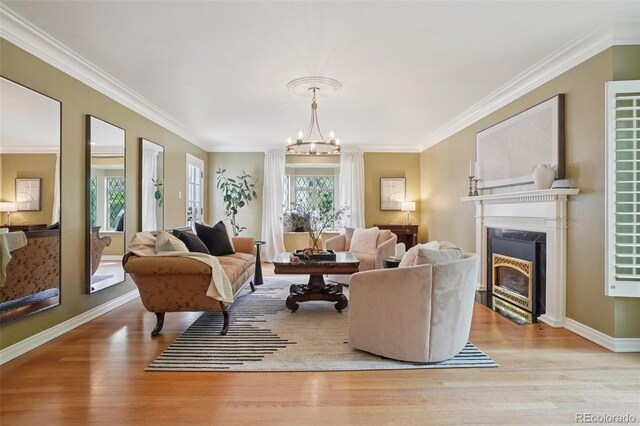 5530 E 6th Avenue Parkway, Denver, CO 80220 - living area featuring a premium fireplace, wood finished floors, a chandelier, ornamental molding, and baseboards