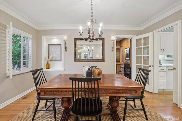 5530 E 6th Avenue Parkway, Denver, CO 80220 - dining room with a chandelier, light wood-style flooring, crown molding, and baseboards