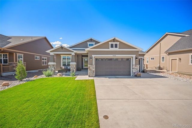 1485 Captiva Beach Ln, Monument, CO 80132 - craftsman-style home featuring stucco siding, driveway, stone siding, a front yard, and a garage