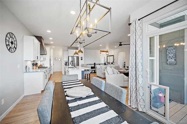 1485 Captiva Beach Ln, Monument, CO 80132 - dining space with light wood-style floors, recessed lighting, a ceiling fan, and a chandelier