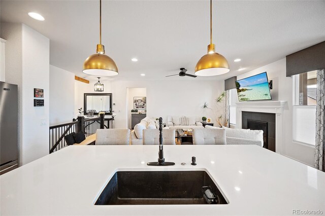 1485 Captiva Beach Ln, Monument, CO 80132 - kitchen with light countertops, a fireplace, pendant lighting, recessed lighting, and refrigerator