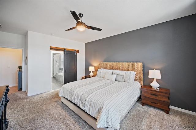 1485 Captiva Beach Ln, Monument, CO 80132 - bedroom featuring a barn door, carpet flooring, a ceiling fan, and ensuite bath