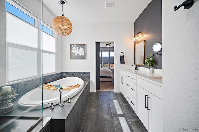 1485 Captiva Beach Ln, Monument, CO 80132 - full bathroom with double vanity, a bath, a chandelier, wood finished floors, and ensuite bathroom
