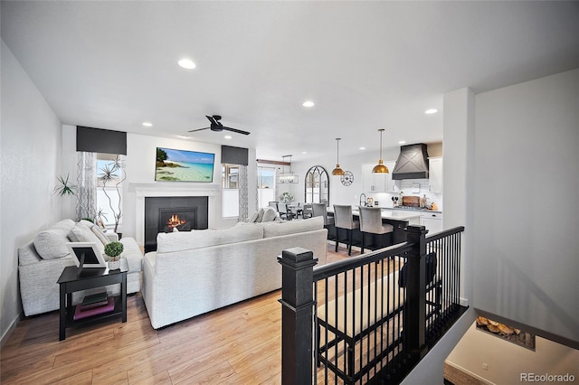 1485 Captiva Beach Ln, Monument, CO 80132 - living room with light wood-type flooring, ceiling fan, recessed lighting, a fireplace, and plenty of natural light