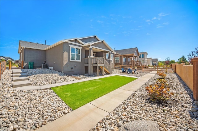 1485 Captiva Beach Ln, Monument, CO 80132 - rear view of property featuring stairway, stucco siding, a fenced backyard, and a residential view