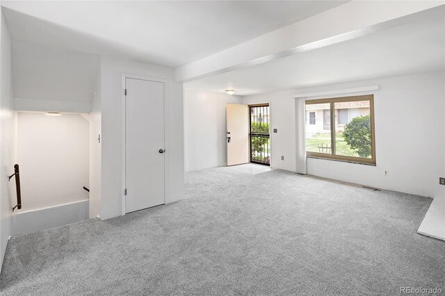 carpeted empty room featuring visible vents