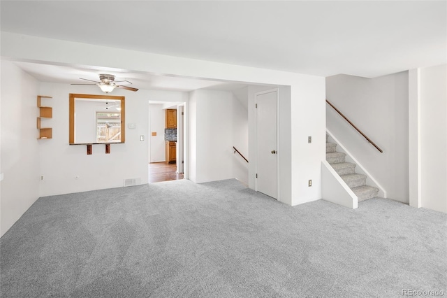 carpeted empty room featuring ceiling fan and visible vents