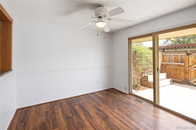 unfurnished room with a ceiling fan, a textured ceiling, baseboards, visible vents, and wood finished floors