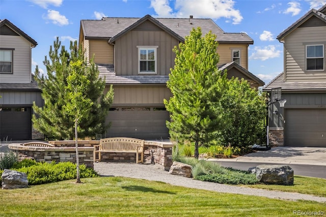10401 Maplebrook Way, Highlands Ranch, CO 80126 - view of front facade featuring board and batten siding, stone siding, an attached garage, and a front yard