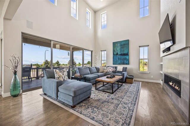 10401 Maplebrook Way, Highlands Ranch, CO 80126 - living area with a towering ceiling, wood finished floors, and a tile fireplace