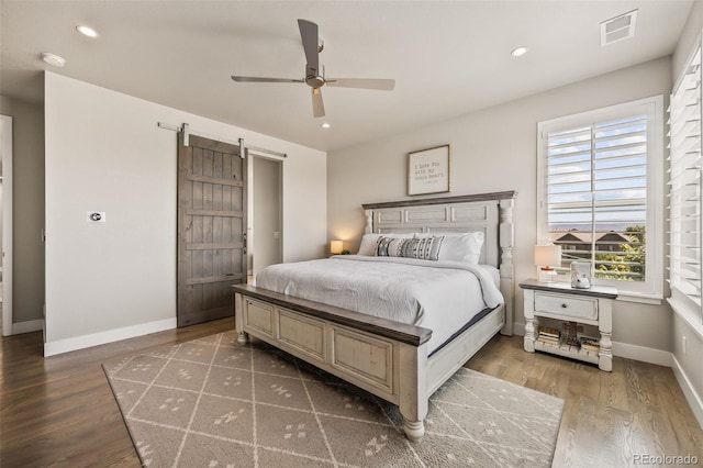10401 Maplebrook Way, Highlands Ranch, CO 80126 - bedroom featuring wood finished floors, a barn door, recessed lighting, and a ceiling fan