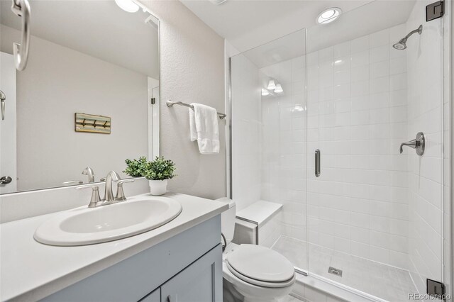 10401 Maplebrook Way, Highlands Ranch, CO 80126 - bathroom featuring vanity, a stall shower, and a textured wall