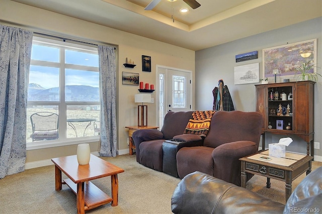 living room featuring a wealth of natural light, baseboards, and ceiling fan