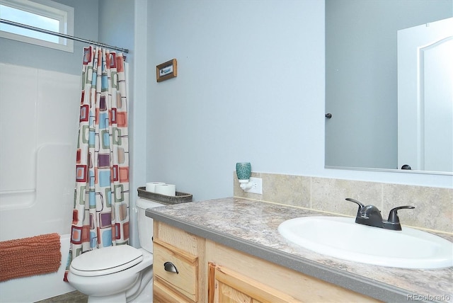 bathroom with toilet, a shower with shower curtain, and vanity